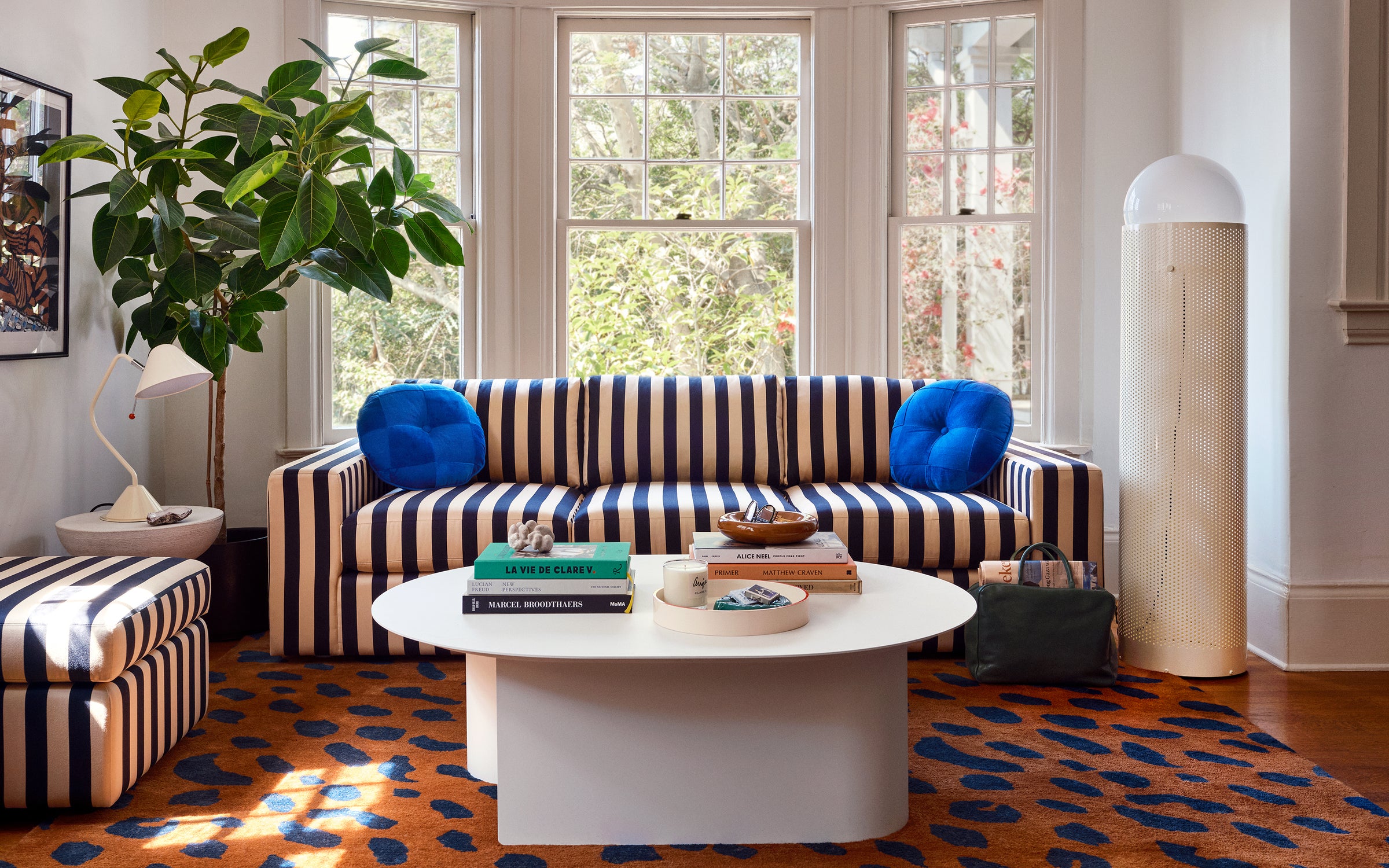 CV x Schoolhouse Navy and Cream Striped Sofa and Jaguar Rug. 