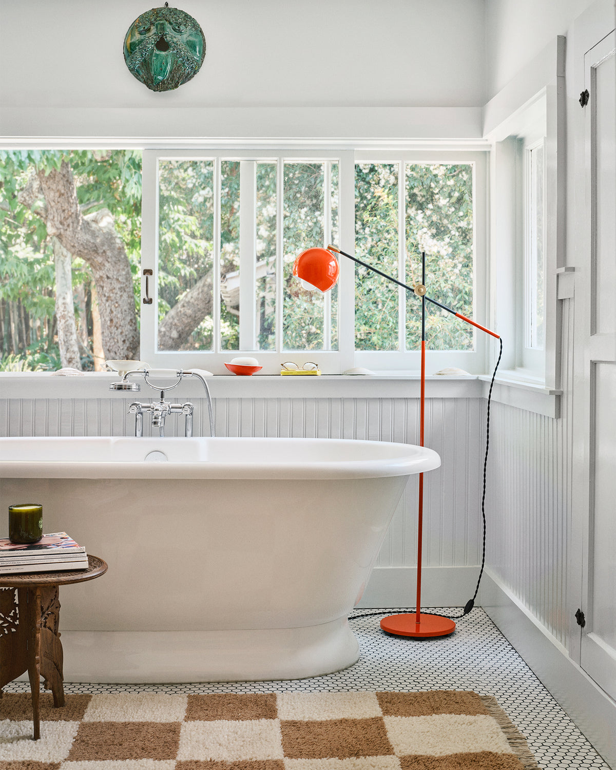 Bathroom with CV x Schoolhouse lamp  and checkered rug. 
