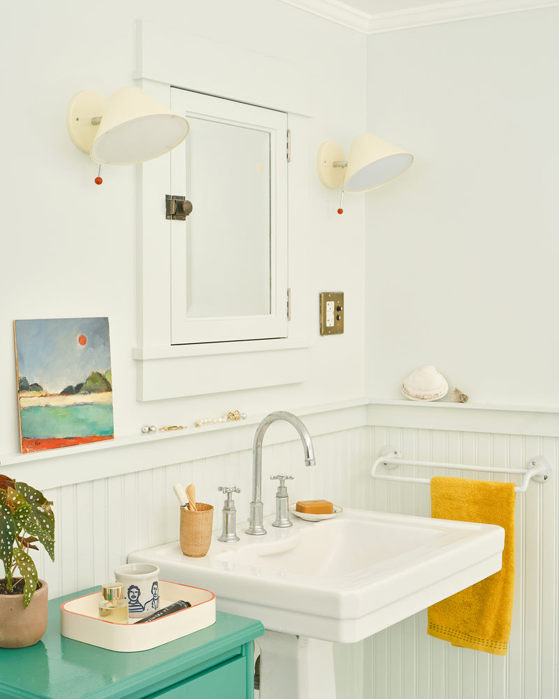 Bathroom interior showing CV x Schoolhouse lighting fixtures. 