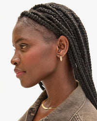 Noma wearing Le Link Huggie Earrings