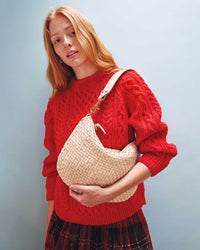 Haley carries the Cream Woven Checker Moyen Messenger on her shoulder