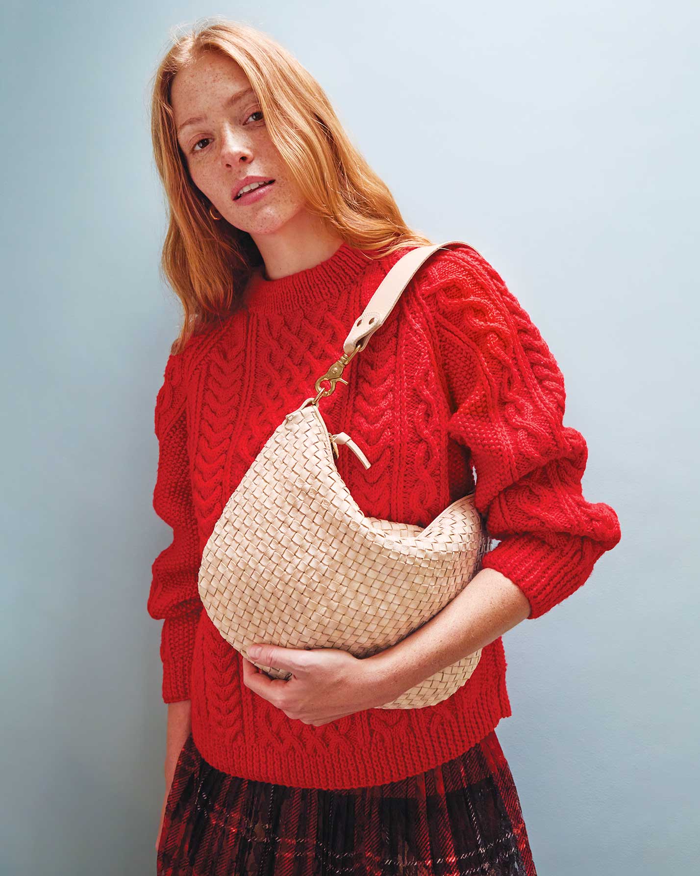 Haley carries the Cream Woven Checker Moyen Messenger on her shoulder