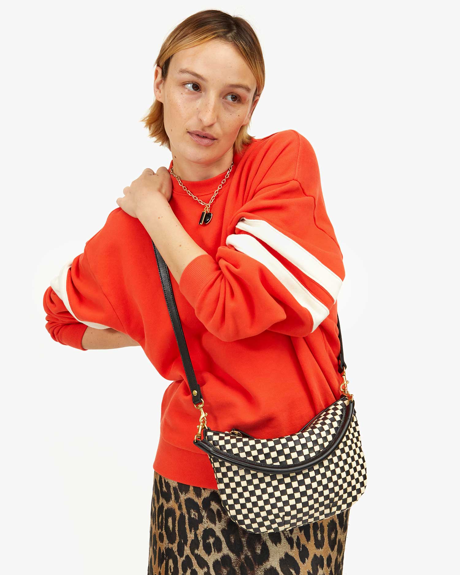 Zoe Wears the Black & Cream Woven Checker Petit Moyen as a Crossbody