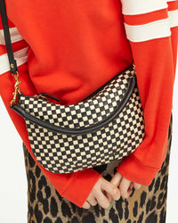 Detail View of Zoe Wearing the Black & Cream Woven Checker Petit Moyen as a Crossbody