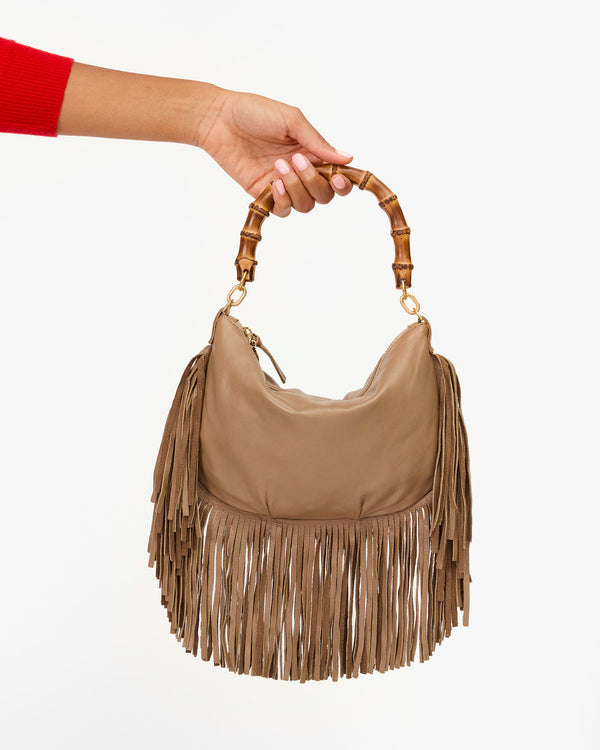 Bree holds Petit Moyen Fringe with Bamboo Handle