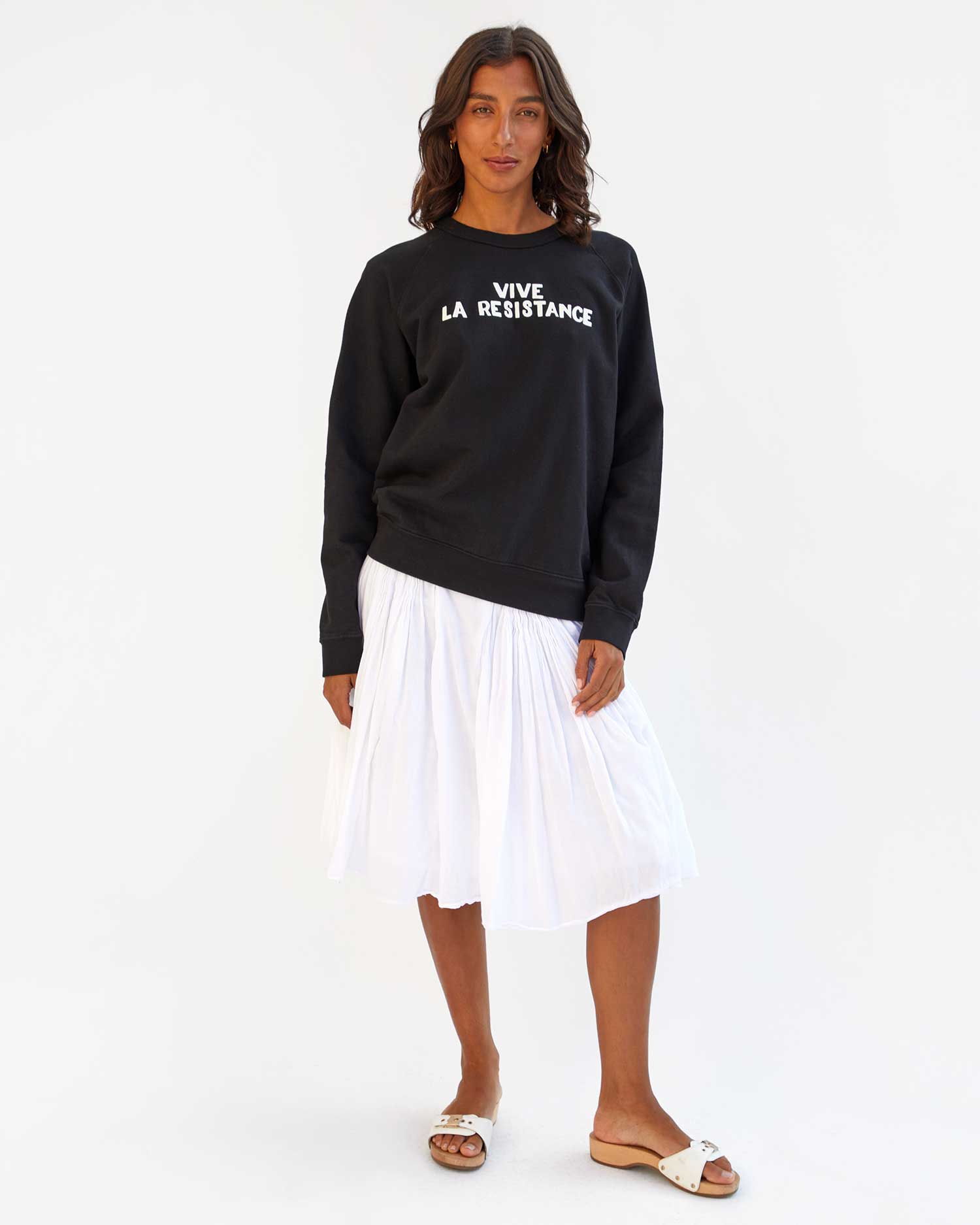 Hayley wears the Black Vive La Resistance Sweatshirt with a White Skirt