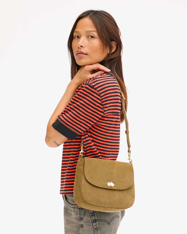 Maly carries the Turnlock Louis in Oat Suede on her Shoulder