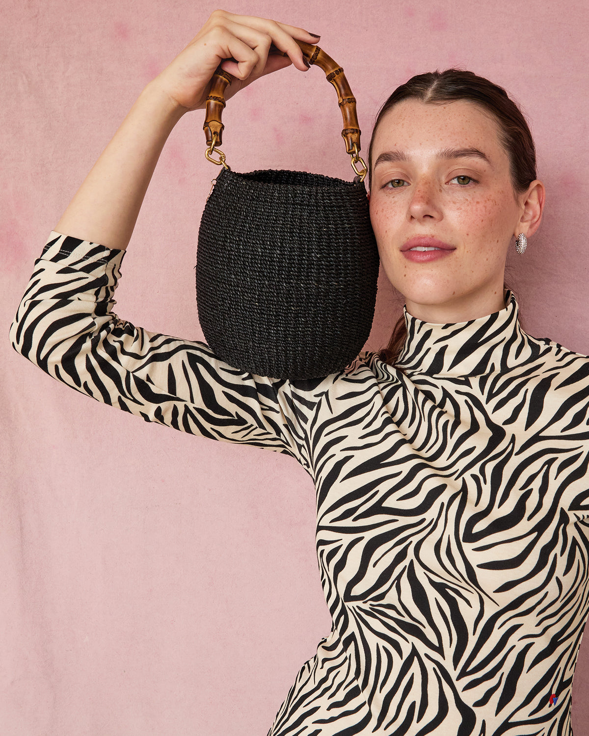 Model holding the Black Pot de Miel with Bamboo Handle. 