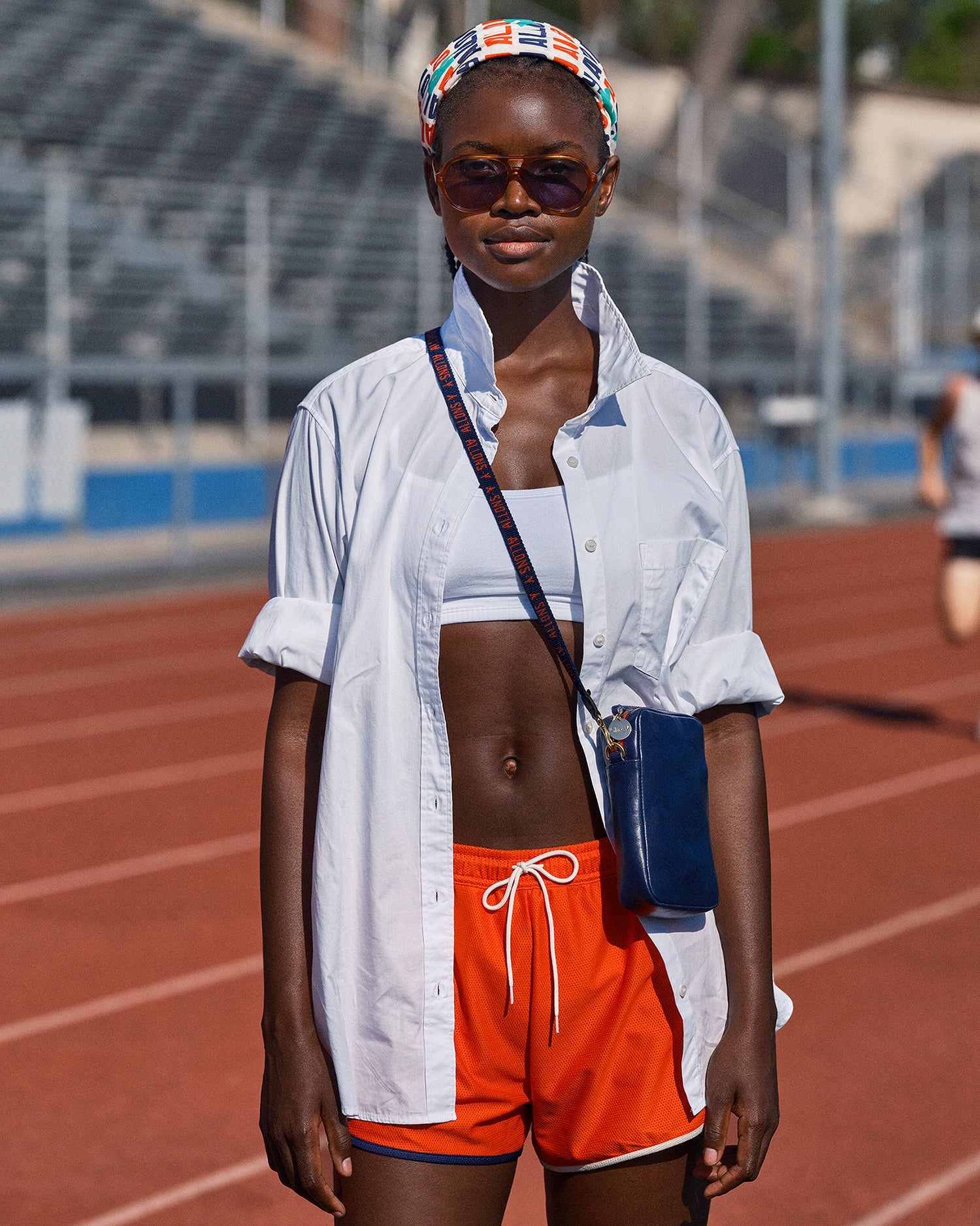 Model wearing the CV x Tracksmith Bandana, Shorts, and Poche Sportif.