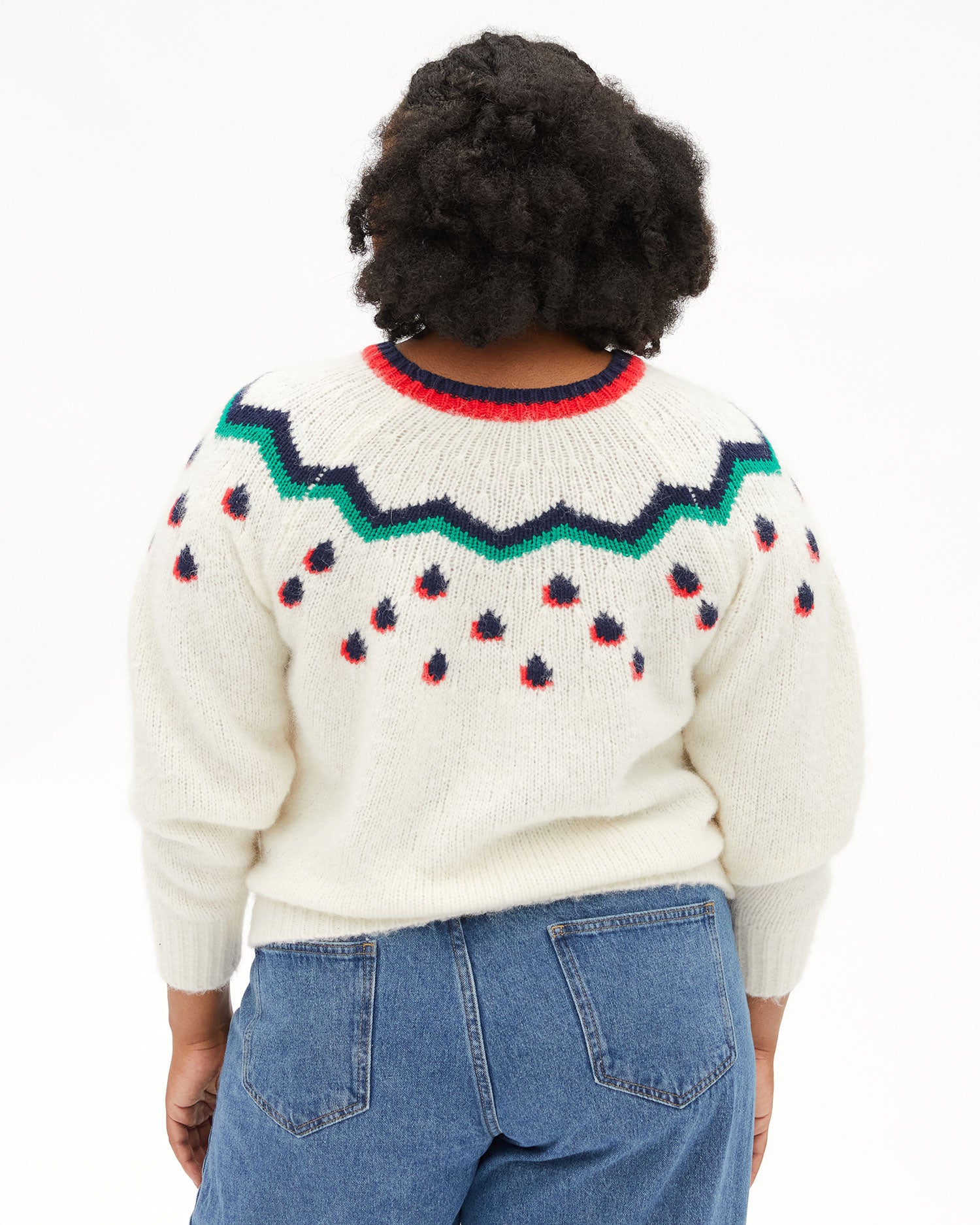 Back view of Candace in the Cream Multi Fair Isle Ragland Sweater and jeans