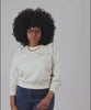 Candace wearing the Cream Charlotte Sweatshirt and  twirling to show the back.